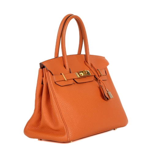 314 - Hermes, a 2004 Birkin 30 handbag, designed with a grained orange leather exterior with gold-plated h... 