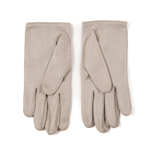 319 - Hermes, a pair of vintage leather gloves, crafted from pale grey lambskin leather, featuring a silve... 