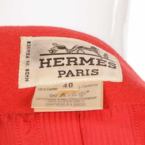 329 - Hermes, a 1980s red cashmere jacket, featuring a V-neck, front button fastenings, two exterior patch... 