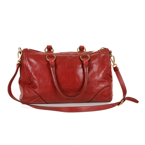 384 - Prada, a red Vitello Shine handbag, featuring a glossy red leather exterior, with gold-tone hardware... 