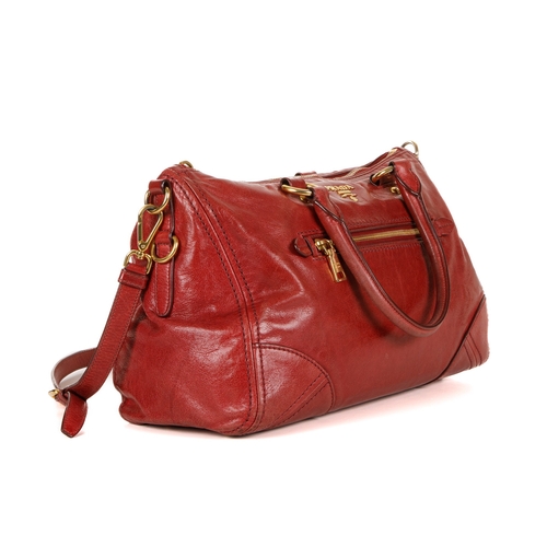 384 - Prada, a red Vitello Shine handbag, featuring a glossy red leather exterior, with gold-tone hardware... 