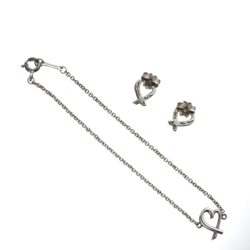 402 - Tiffany & Co., a Paloma Picasso 'Loving Heart' bracelet and matching stud earrings, featuring a cros... 