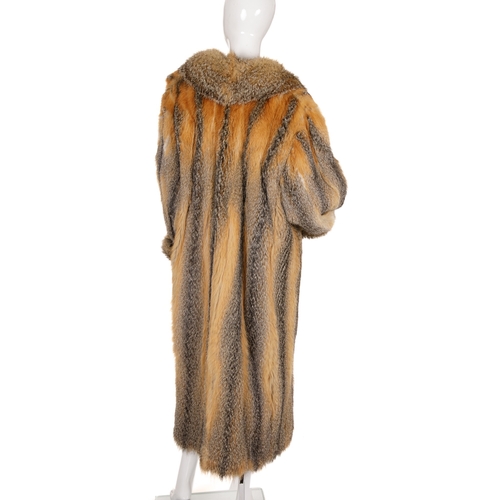 440 - A full-length coyote wolf fur coat, featuring a notched lapel collar, hook and eye clip fastenings, ... 