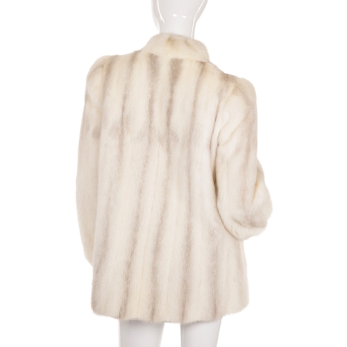 442 - An azurene/pearl mink fur jacket, designed with a short Mandarin collar with long hanging neck ties,... 