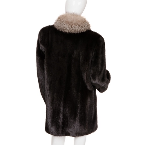 443 - A black mink and fox fur coat, featuring silver fox fur collar and trim, with barrel sleeves and fit... 