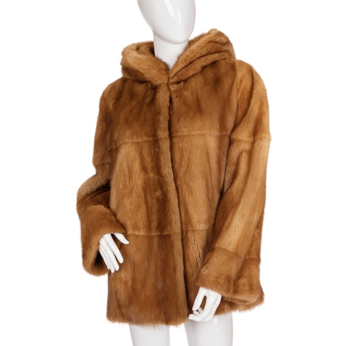 447 - A gold mink hooded coat, featuring hook and eye clip fastenings, a large fur-lined hood and two oute... 