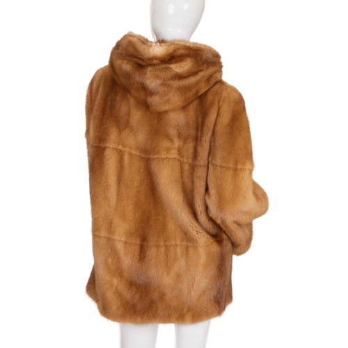 447 - A gold mink hooded coat, featuring hook and eye clip fastenings, a large fur-lined hood and two oute... 