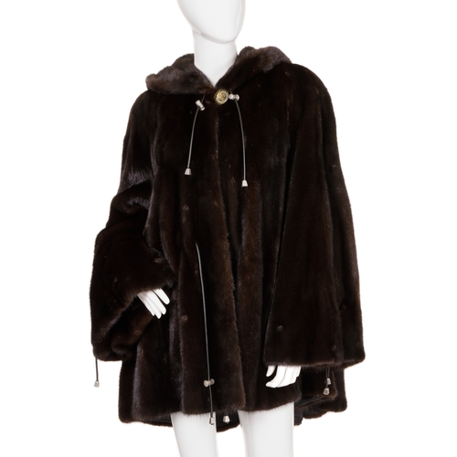 448 - A ranch mink hooded swing coat, designed with a large fur-lined hood with black leather drawcords an... 