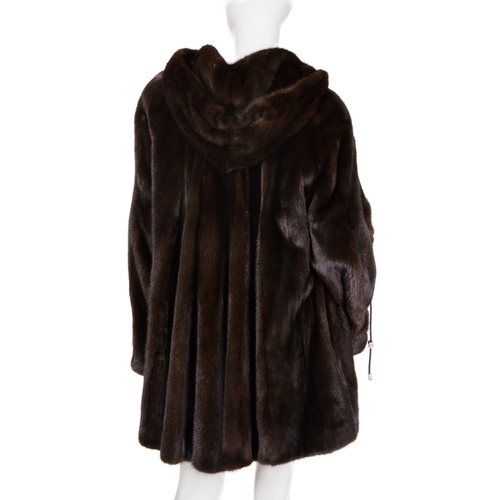 448 - A ranch mink hooded swing coat, designed with a large fur-lined hood with black leather drawcords an... 