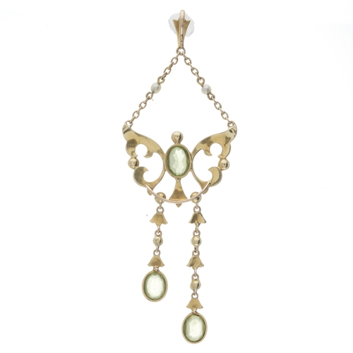 5 - An Edwardian gold peridot and split pearl openwork pendant, with split pearl surmount and seed pearl... 