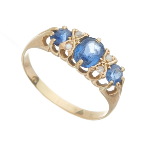 6 - An Edwardian 18ct gold graduated sapphire three-stone dress ring, with rose-cut diamond double space... 