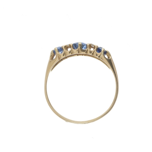 6 - An Edwardian 18ct gold graduated sapphire three-stone dress ring, with rose-cut diamond double space... 