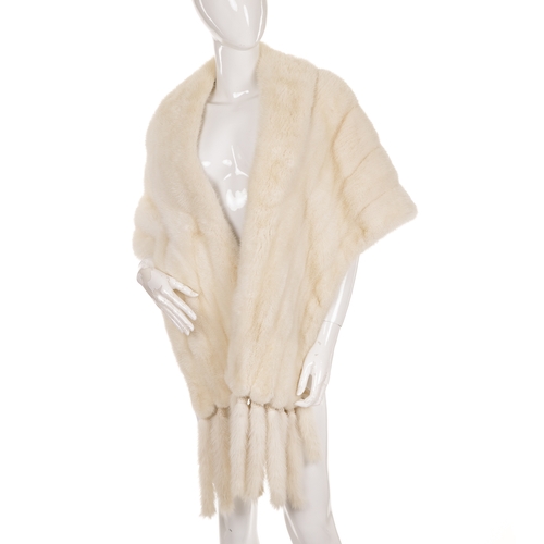 455 - A white mink fur cape/stole, featuring a lapel collar, scalloped edge details, removable mink tassel... 