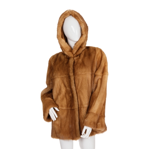 447 - A gold mink hooded coat, featuring hook and eye clip fastenings, a large fur-lined hood and two oute... 