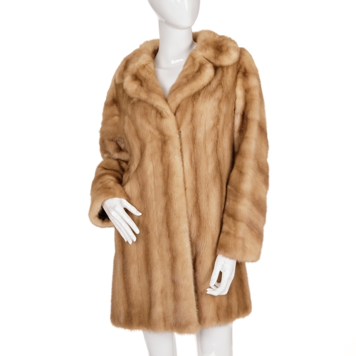 441 - A three-quarter length pastel mink coat, featuring a notched lapel collar, hook and eye fastenings, ... 