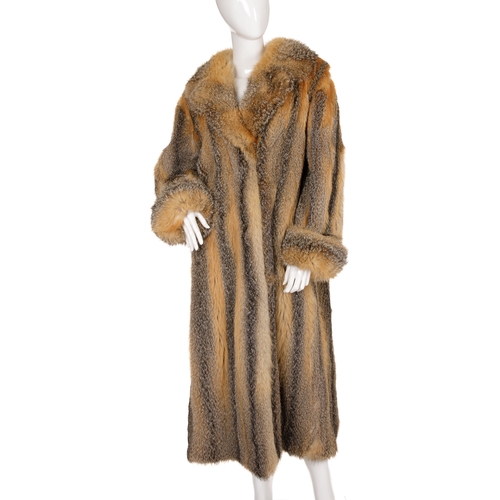 440 - A full-length coyote wolf fur coat, featuring a notched lapel collar, hook and eye clip fastenings, ... 