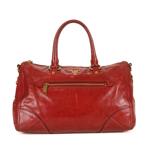 384 - Prada, a red Vitello Shine handbag, featuring a glossy red leather exterior, with gold-tone hardware... 