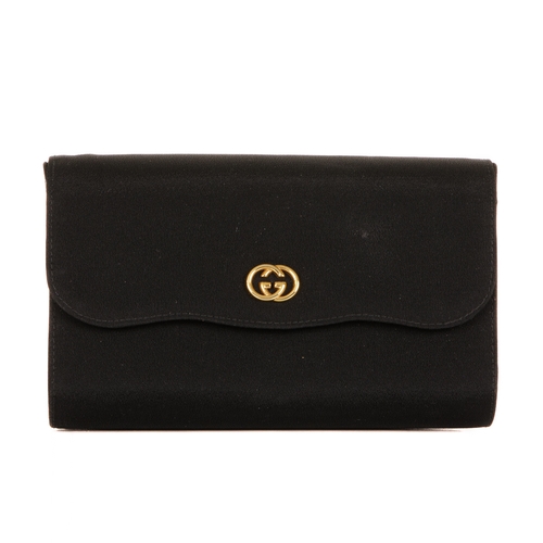 305 - Gucci, a vintage clutch, designed with a structured shape, with a black fabric exterior, gold-tone G... 