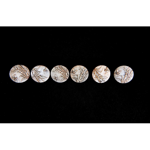 117 - A boxed set of six Aesthetic Movement silver plated buttons, cast in relief with dragonfly and bambo... 