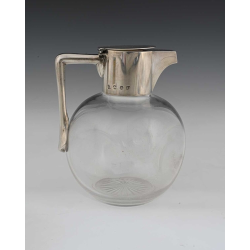 120 - Christopher Dresser for Hukin and Heath, an Aesthetic movement silver mounted glass claret jug, John... 