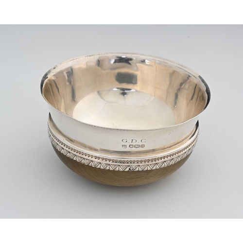 125 - An Arts and Crafts silver and turned wood mazer bowl inscribed 'G. D. C.', 12cm diameter