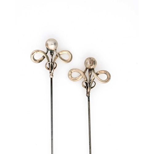 13 - Charles Horner, a cased pair of Arts and Crafts silver hat pins, knotted ribbon form