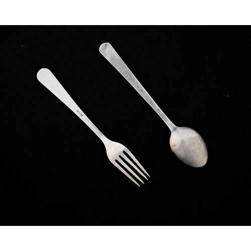 132 - An Arts and Crafts silver christening or childs spoon and fork set, planished, the terminals chased ... 