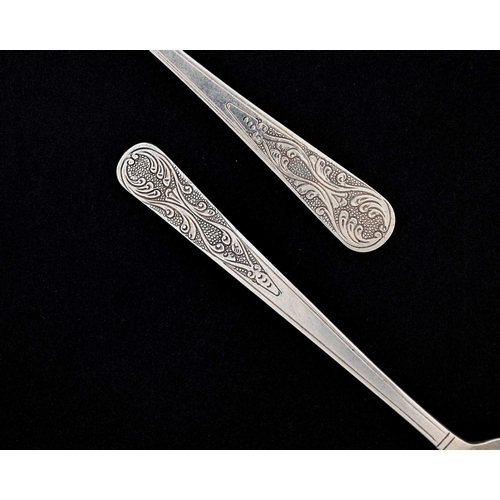 132 - An Arts and Crafts silver christening or childs spoon and fork set, planished, the terminals chased ... 