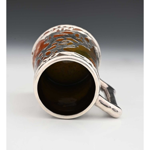 136a - A silver overlay ceramic tankard, J B Owens, in the Rookwood style with reticulated and chased tendr... 