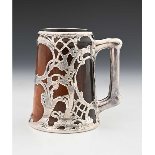 136a - A silver overlay ceramic tankard, J B Owens, in the Rookwood style with reticulated and chased tendr... 