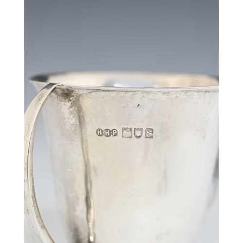 151 - An Arts and Crafts silver twin handled footed cup, Henry Hodson Plante, London 1913, planished flare... 