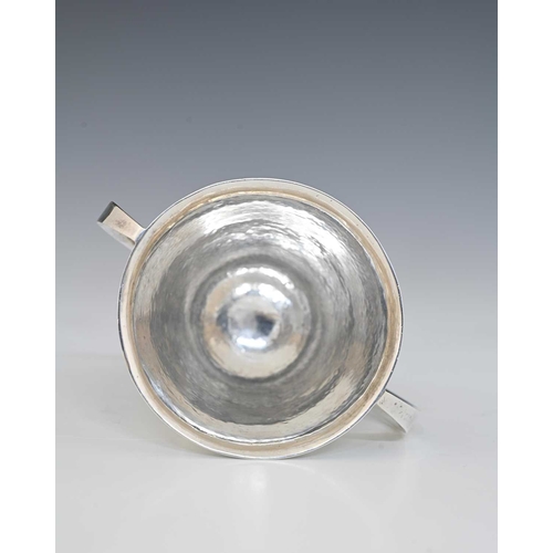 151 - An Arts and Crafts silver twin handled footed cup, Henry Hodson Plante, London 1913, planished flare... 