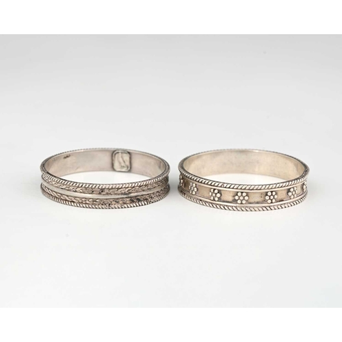 154 - H G Murphy, two Arts and Crafts silver napkin rings, circa 1920s, applied ropetwist bands with bead ... 