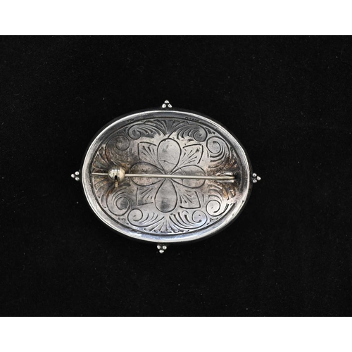 16 - An Arts and Crafts silver and mother of pearl brooch, in the style of Edward Spencer for the Artific... 