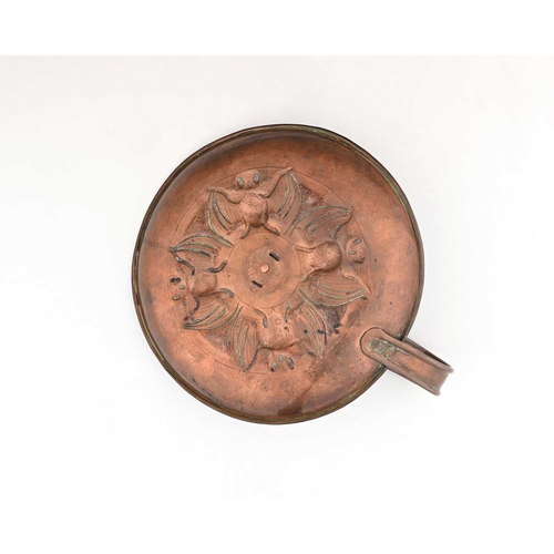 174 - An Arts and Crafts repousse copper chamberstick, embossed and chased with a band of bats around a ce... 