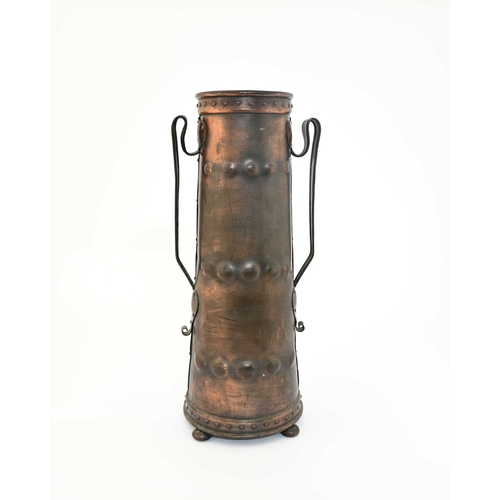 177 - A large Arts and Crafts repousse copper vase, twin handled conical form with riveted bands and handl... 