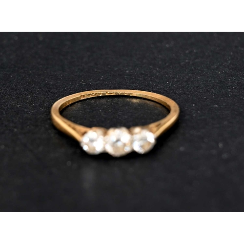 2 - An 18 carat gold three stone diamond ring, size J 1/2, 1.4g