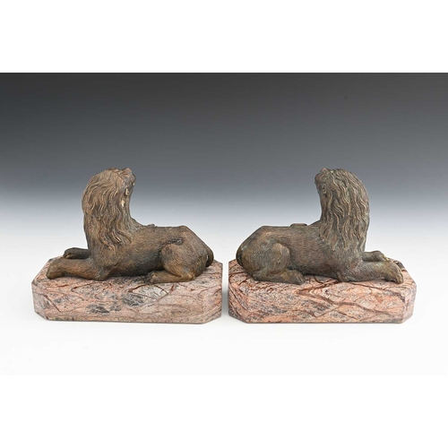 210A - A pair of Italian bronze and marble figures of lions, in the Medieval Renaissance style, modelled re... 