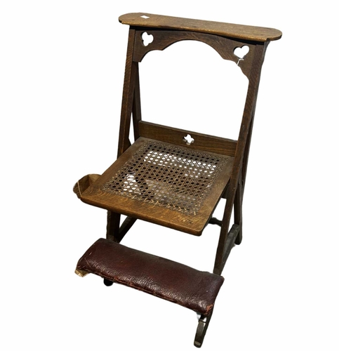 239 - A Victorian Gothic Revival oak prayer chair, circa 1860s, the hinged cane seat on a buttressed joint... 