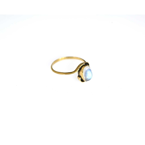 24 - An Arts and Crafts gold and moonstone ring, in the style of Murrle Bennett, the central cabochon sto... 