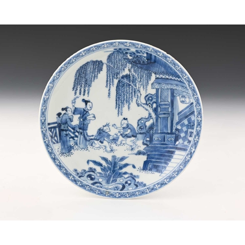 371 - A Chinese blue and white plate, painted with a scene of attendants and boys playing in a pavilion ga... 