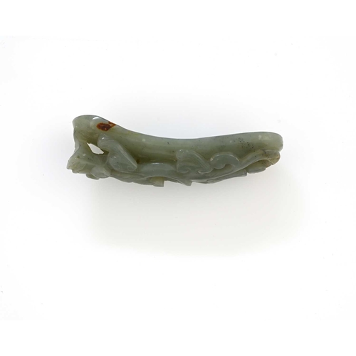 388 - A Chinese carved jade brush rest, arched form, modelled in high relief and reticulated with a recumb... 