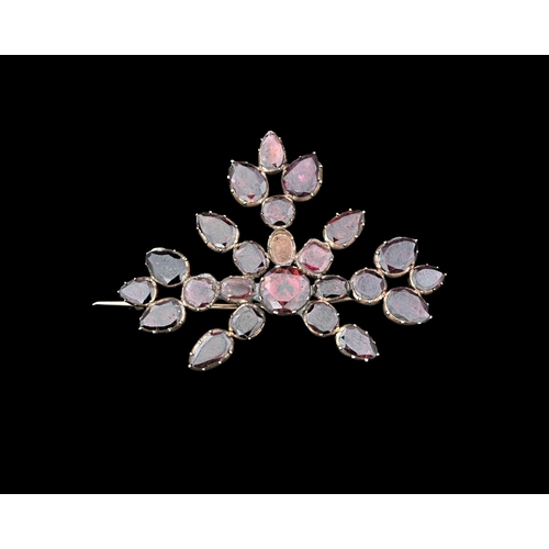 4 - An early 19th century garnet and gold backed brooch, of floral form with variously cut stones, 5.5cm... 