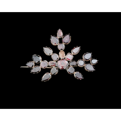 4 - An early 19th century garnet and gold backed brooch, of floral form with variously cut stones, 5.5cm... 