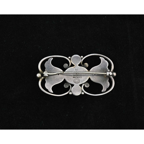 41 - Georg Jensen, a Sknovirke silver brooch, model 236A, open scroll design with two flowers flanking a ... 