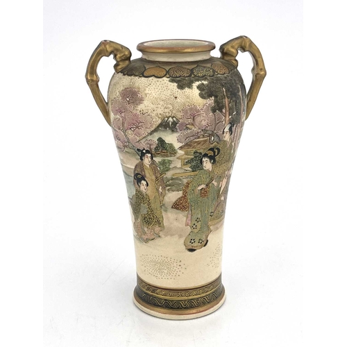 412 - A twin handled Japanese Satsuma vase, Meiji, shouldered form, painted in the round with figures in a... 