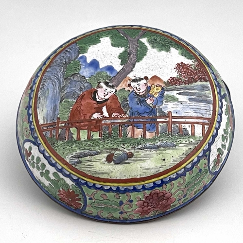 420 - A Chinese Canton enamelled box and cover, circular bun form, painted with two boys by a fence in a g... 