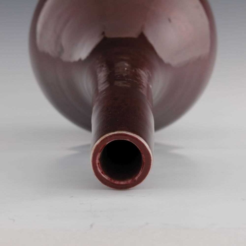 423 - A 19th century Chinese sang de boeuf glaze bottle vase, extended neck, 42cm high