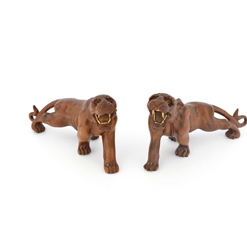 440 - A pair of Japanese carved wood figures of tigers, Meiji, modelled with bone teeth and bead eyes, pai... 