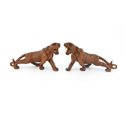 440 - A pair of Japanese carved wood figures of tigers, Meiji, modelled with bone teeth and bead eyes, pai... 